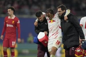 Leipzig’s Xavi Simons helped off the field with injury in Champions League