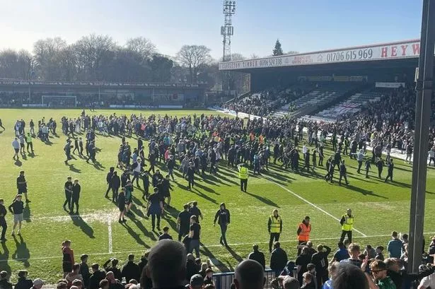 Football match ends in chaos as fans invade pitch and parents ‘cover children’s eyes’