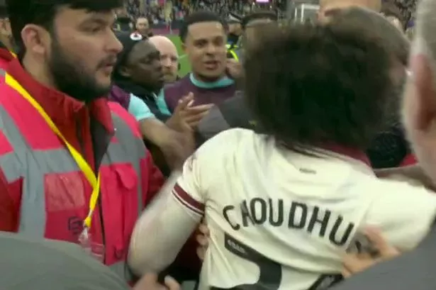 Sheffield United star held back after furious clash with opponents amid pitch invasion chaos
