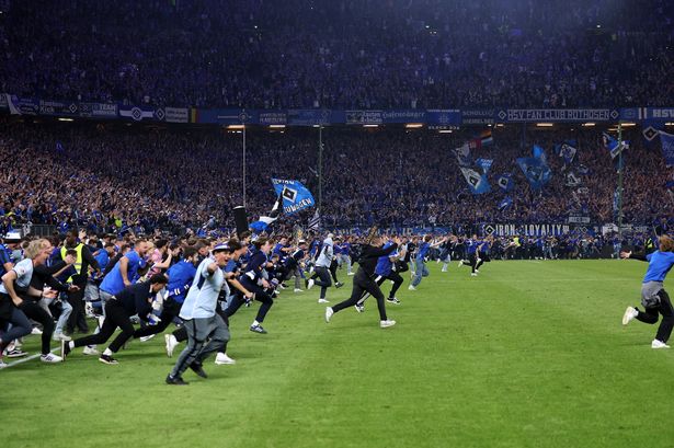 Huge pitch invasion sees 25 fans rushed to hospital and one suffer ‘life-threatening injuries’